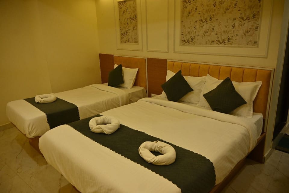 Deluxe Quadruple Room, City View | Desk, laptop workspace, blackout drapes, iron/ironing board
