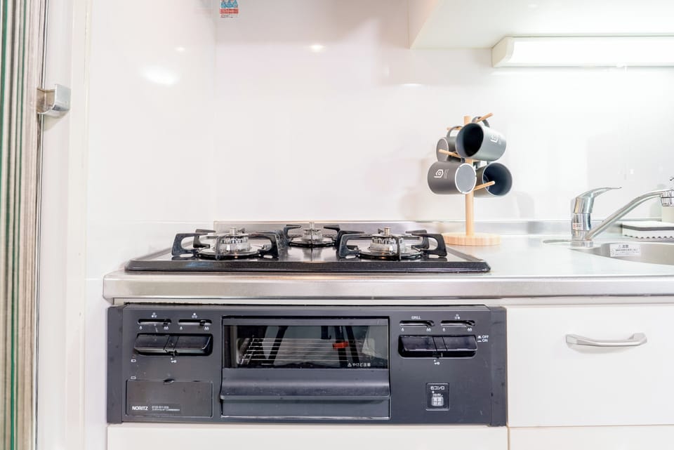 Deluxe Quadruple Room, Balcony | Private kitchen | Fridge, microwave, stovetop, cookware/dishes/utensils