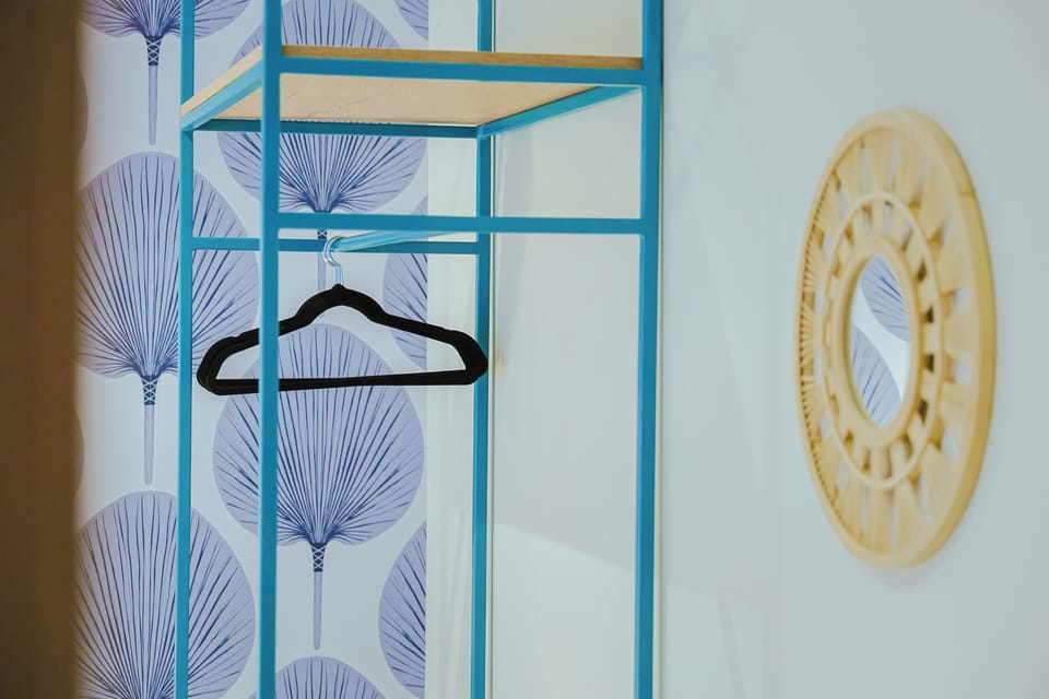 Your wardrobe awaits with tropical-inspired touches and a bright, airy design to keep your belongings organized and accessible.