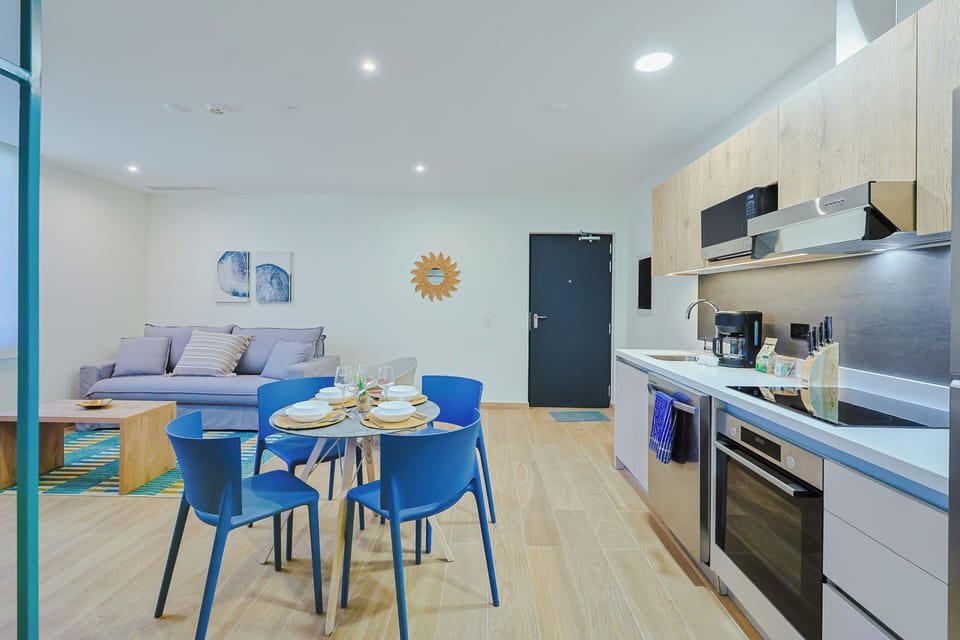 Step into your stylish open-plan retreat, where a modern kitchen and inviting dining space meet a cozy living area—perfect for unwinding after exploring the area.