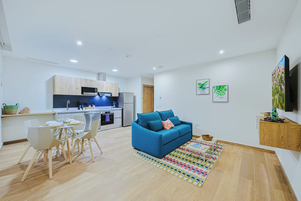 Bright, open-plan living where you'll feel right at home—modern kitchen ready for your morning coffee, a welcoming dining spot, and a vibrant seating area perfect for unwinding after a day of exploring.