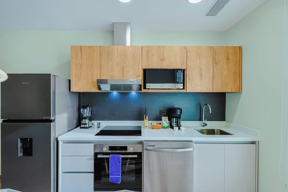 Your fully equipped kitchen features modern appliances and sleek countertops, perfect for preparing home-cooked meals during your stay. Everything you need is right at your fingertips.
