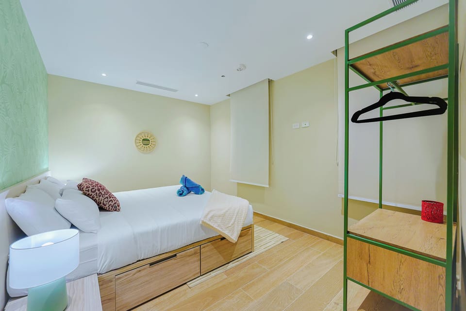 Your bright and airy bedroom features a comfortable bed with fresh linens and smart storage underneath, plus an open wardrobe area to keep your belongings organized throughout your stay.