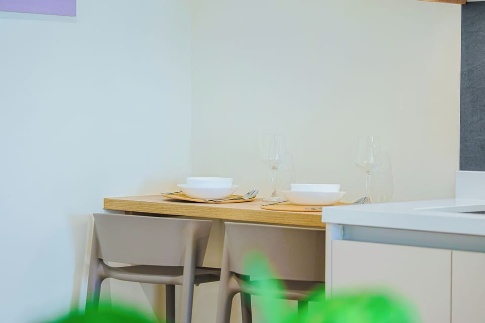 The sleek kitchen bar with two stools offers a comfortable spot for breakfast, light meals, or planning your day's adventures.