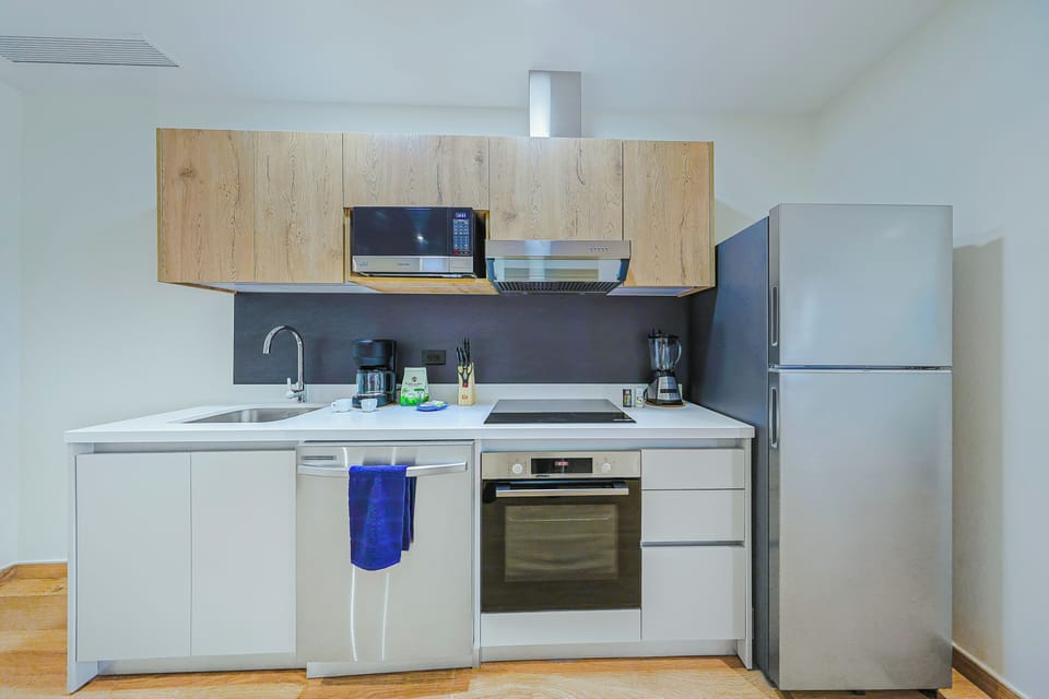 Your fully-equipped kitchen makes meal prep a breeze, with modern appliances and sleek wood-and-white cabinetry for a comfortable home-away-from-home experience.
