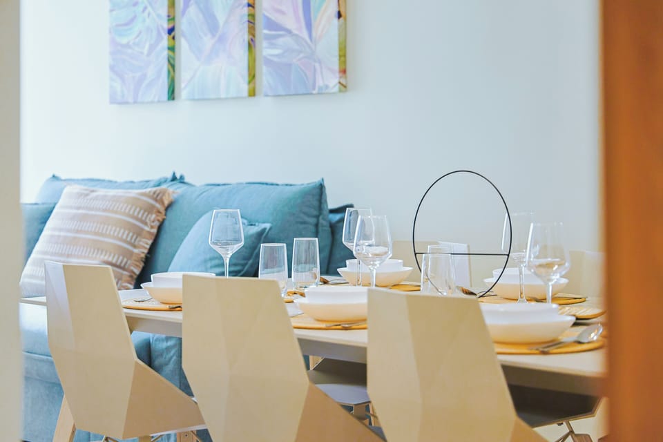 Gather around this elegant dining table beautifully set for your group, with a cozy lounge area just steps away for relaxing after meals.