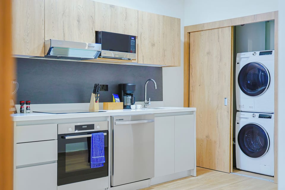 Your fully equipped kitchen makes meal prep effortless, with modern appliances including an oven, microwave, and in-unit washer and dryer for ultimate convenience during your stay.