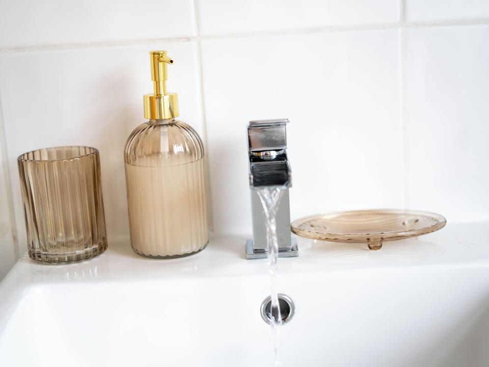 Stylish spa-like sink with elegant bath amenities