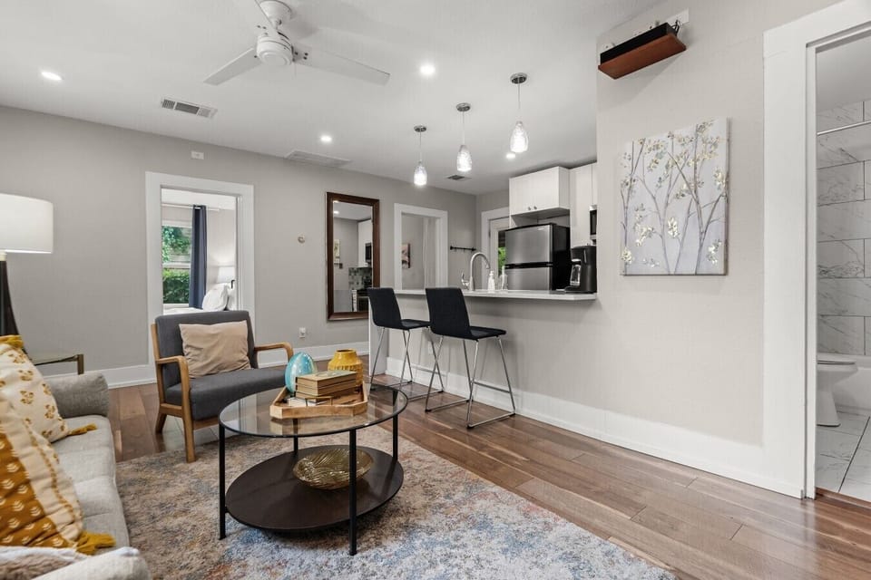 Ceiling fan, breakfast bar, and open flow to the kitchen make this living space comfortable for the whole group.