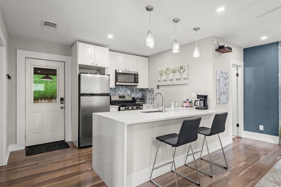 Brew your morning coffee and cook a full dinner in this kitchen with quartz island, gas range, and stainless appliances.