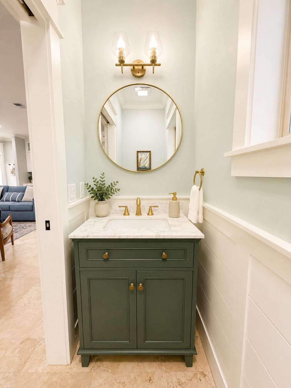 A charming powder room with a bold green vanity and gold accents for guests.