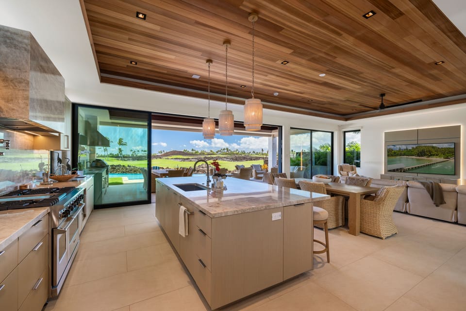 Kitchen, dining, and living share one bright open floor.