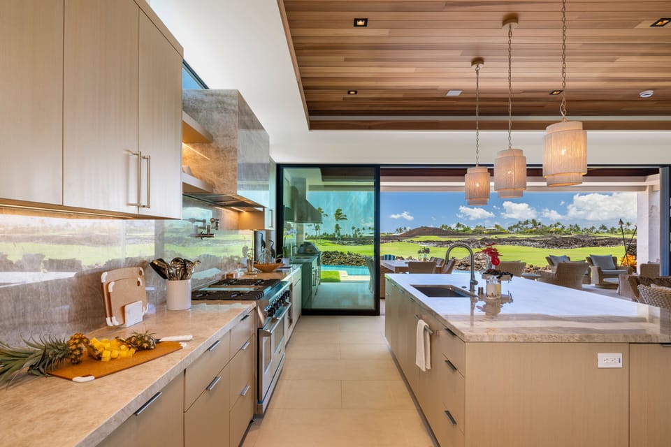 The well-appointed kitchen overlooks the lush fairways, bringing the beauty of the golf course into view.