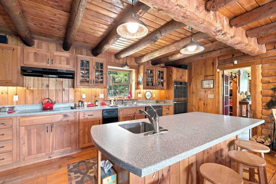 The full kitchen opens right onto the living space, with a big island and bar stools for pulling up while meals come together.