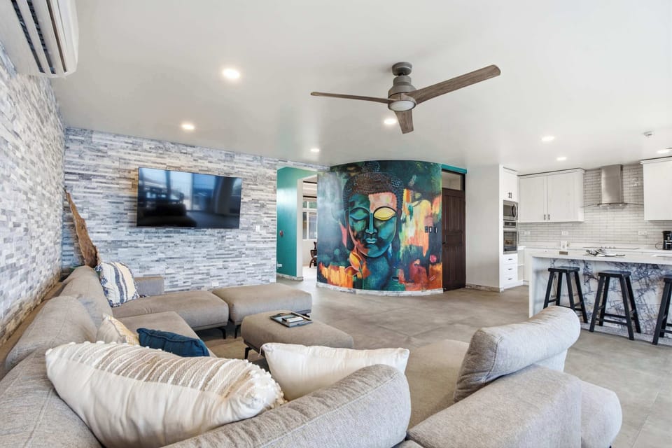 An open living space where colorful art meets ocean light