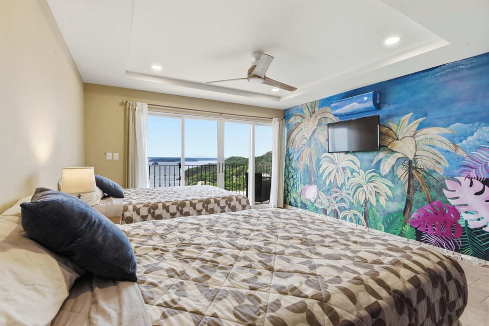 Ocean-inspired artwork brings a splash of color to this bedroom