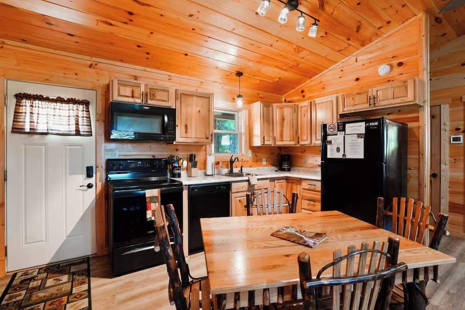 Kitchen: Modern appliances meet rustic charm in a spacious cabin kitchen filled with light!