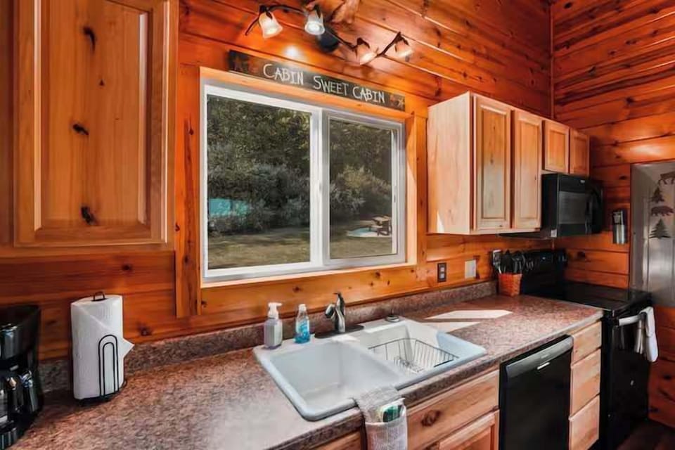 Kitchen: Bright wooden charm with modern appliances and a view of nature’s serenity!