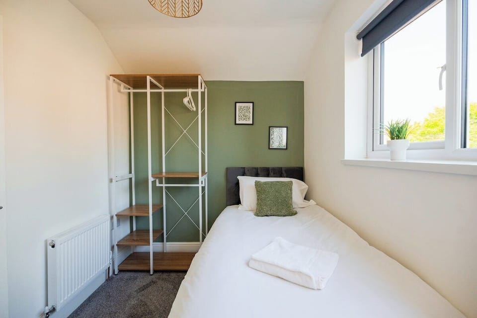 Unwind in the comfortable bed after a busy day, with bedside lighting and a mirror making it easy to settle in. Guests can relax, get ready for the day and enjoy a restful night with the wardrobe providing convenient storage during their stay.