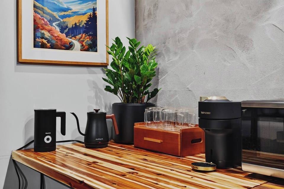Coffee station in the Garden Suite with a Nespresso machine, kettle, microwave, and glassware.