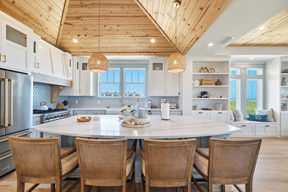 You'll love the bright open kitchen with soaring vaulted wood ceilings and a spacious island perfect for preparing meals or gathering with loved ones.