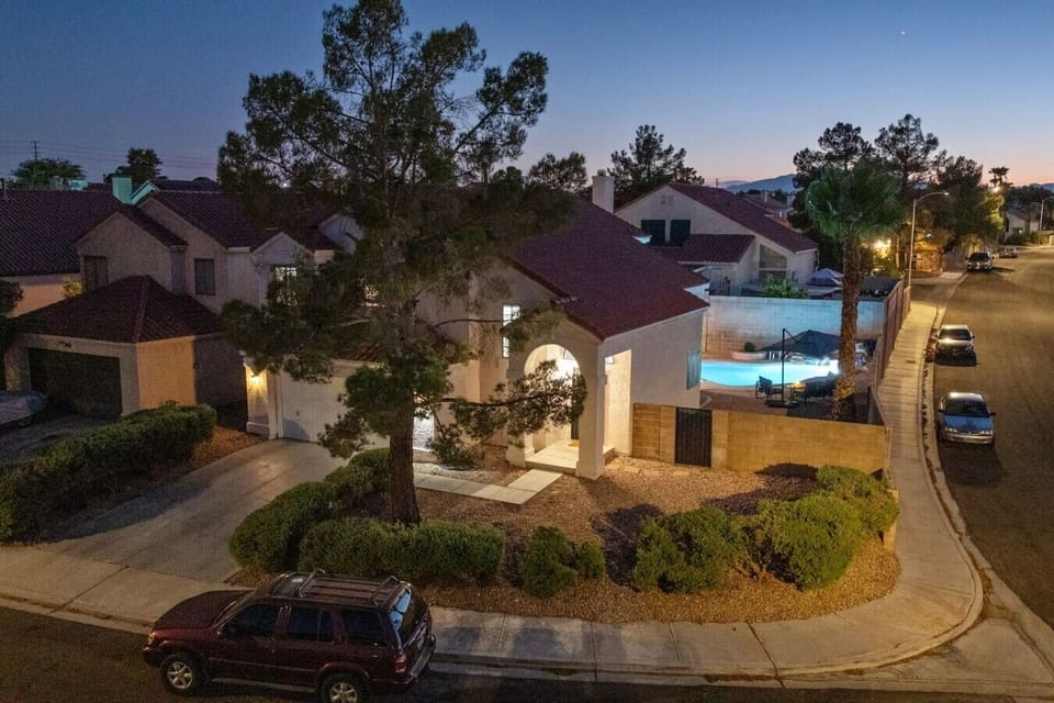 Aerial evening view of the home and private pool