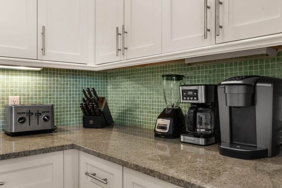 Bright kitchen with granite counters and coffee station essentials