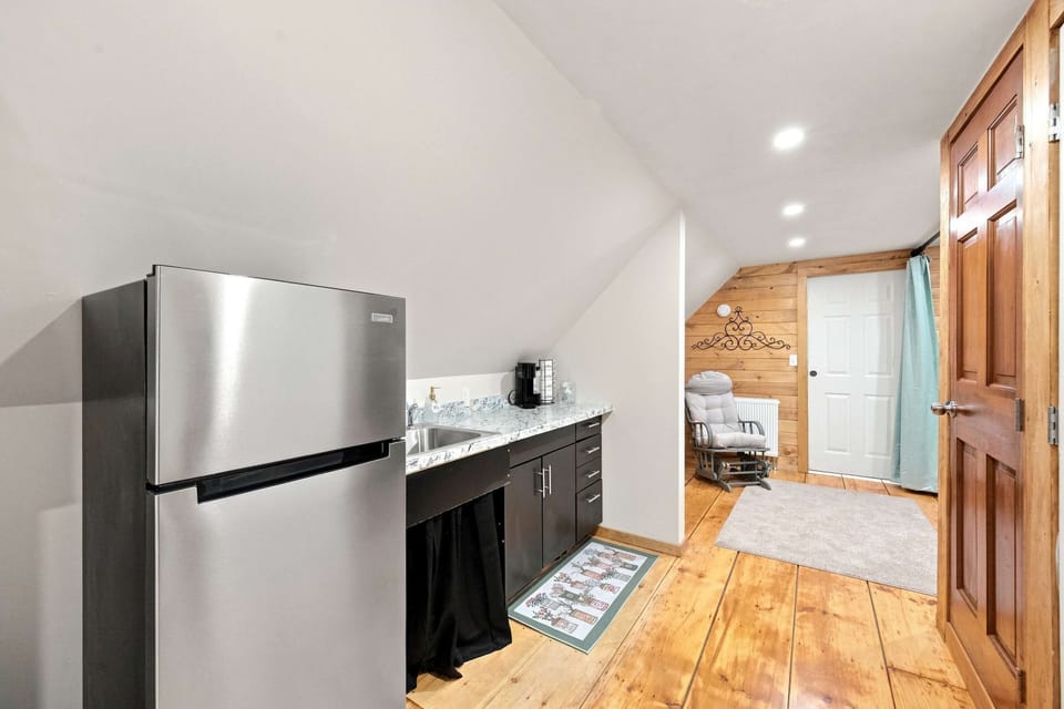 The upstairs kitchenette comes with a stainless fridge, coffee, and counter space, so early risers never have to head downstairs.