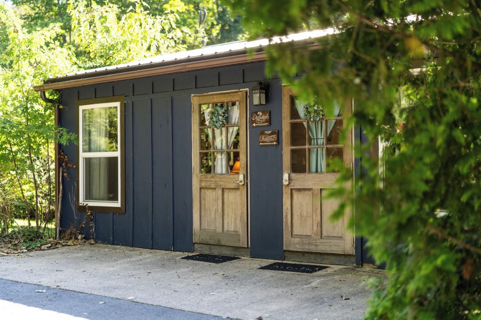 Charming wooded cabin entry with rustic doors and peaceful privacy