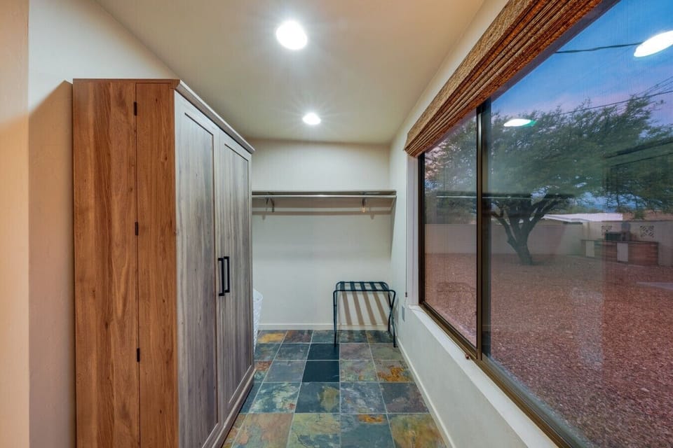 Bedroom 2 Closet Space — Off the queen bedroom, plenty of hanging space plus a wardrobe and luggage rack — room to actually unpack