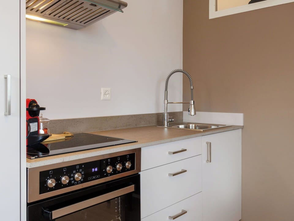 Kitchen, Cabinetry, Kitchen Appliance, Countertop, Wood, Interior Design, Flooring, Major Appliance, Furniture, Lighting