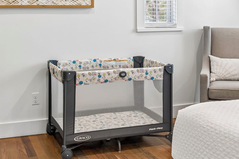 A pack 'n play is ready and waiting for your littlest traveler.