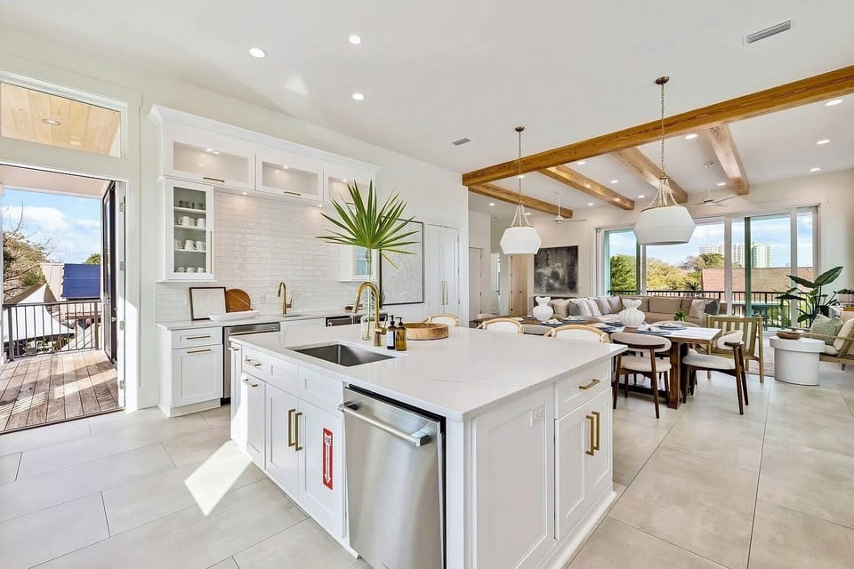 Gourmet chef’s kitchen featuring an expansive quartz island with breakfast bar seating for 4.