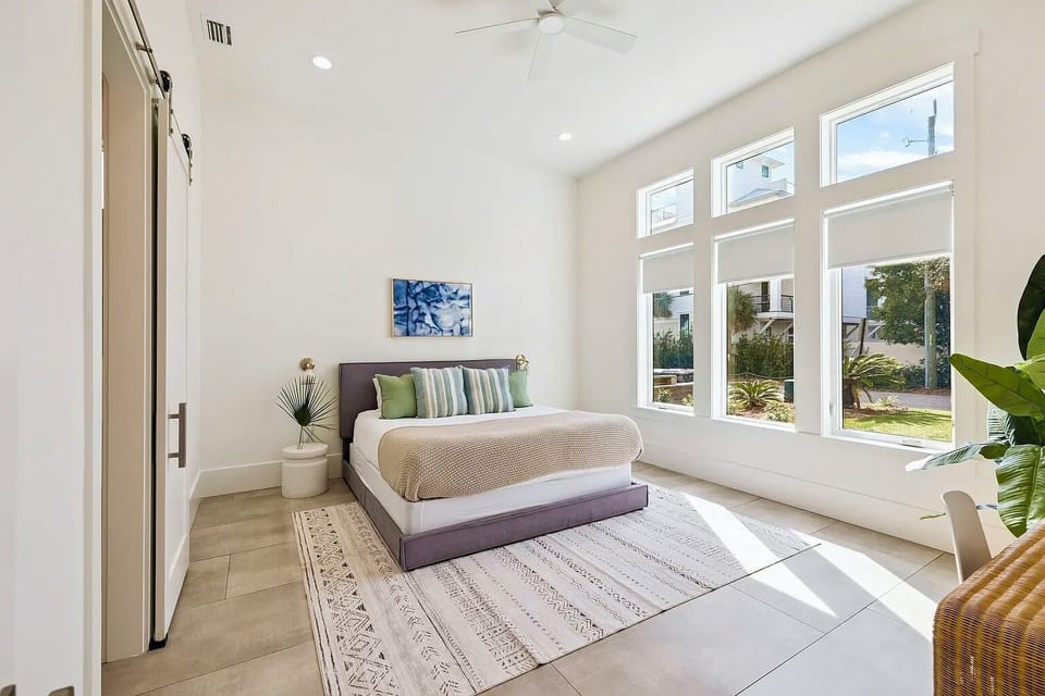 1st-Floor King Suite #1 featuring bright natural lighting, plush king mattress, and private en-suite bathroom.