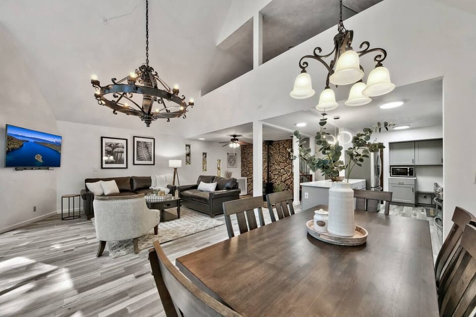 Gather around the dining table with family and friends in this spacious open-concept cabin, featuring vaulted ceilings, cozy seating, and plenty of room to make lasting mountain memories.