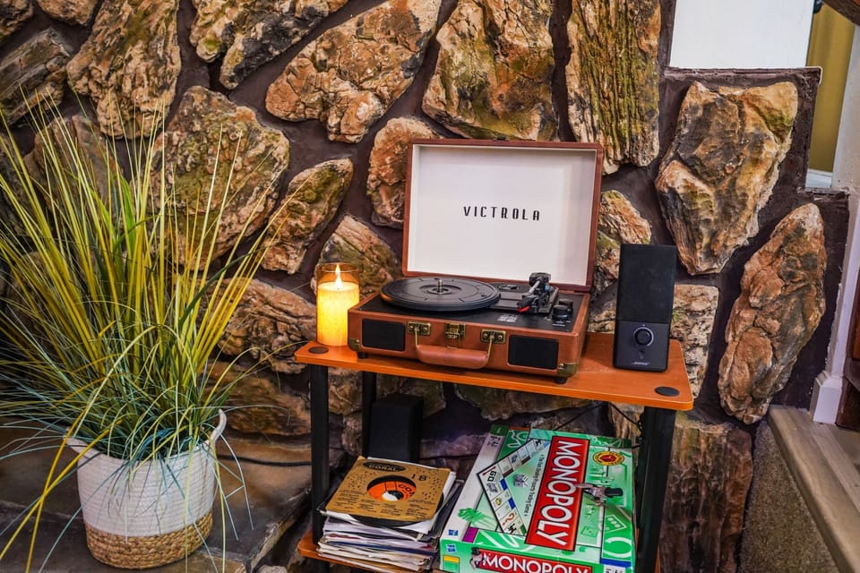 Cozy record player nook with stone wall charm and vintage entertainment