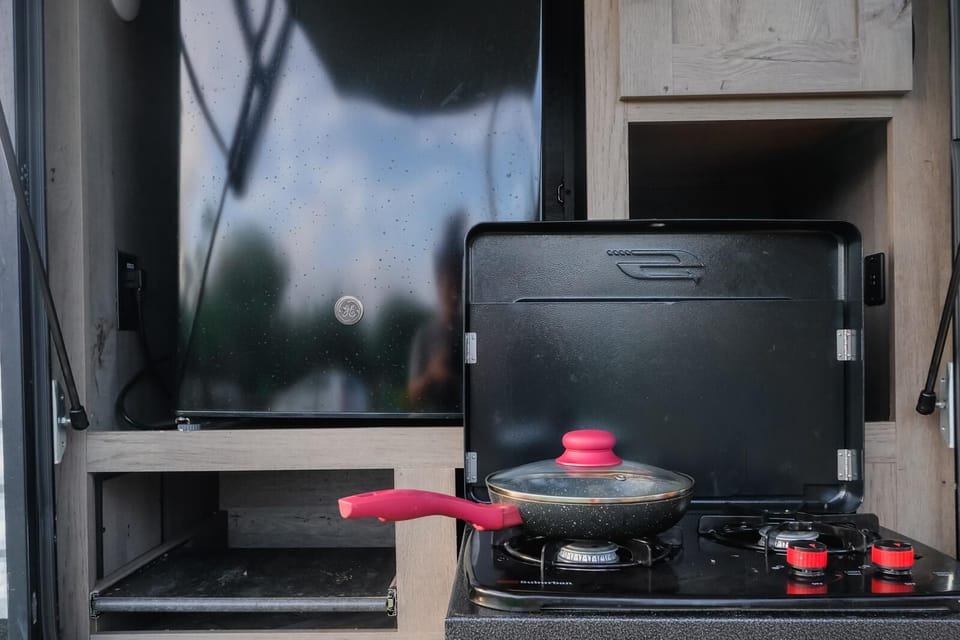 Outside kitchen: gas stove and fridge