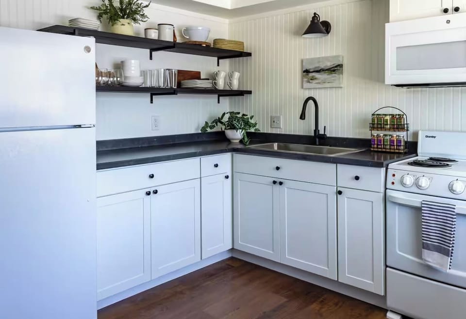 Crisp white cabinetry and open shelving give this kitchen an airy, put-together feel for cooking up something good.