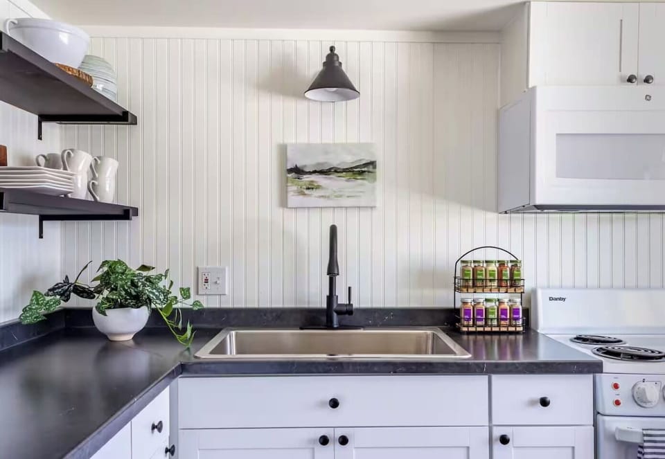 Natural light, greenery, and thoughtful touches make even dishwashing feel a little less like a chore.