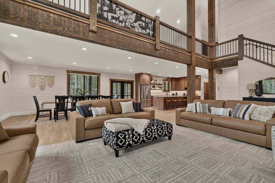 Spacious living area with seating, kitchen, dining and loft above.