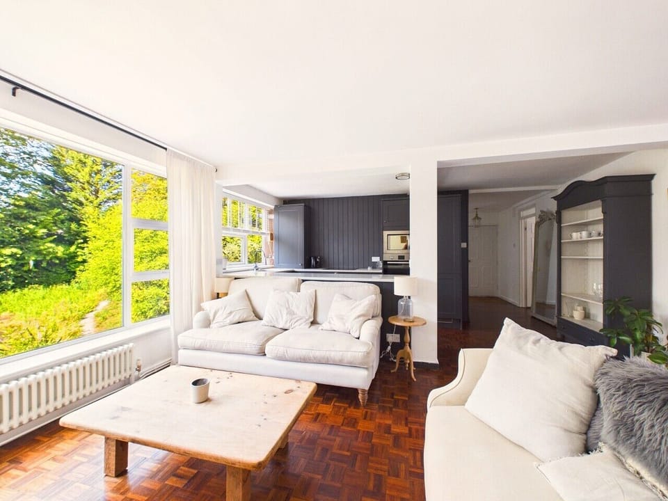 A second, sunnier seating area looks straight out into the trees and opens through to the kitchen, ideal for unhurried breakfasts.