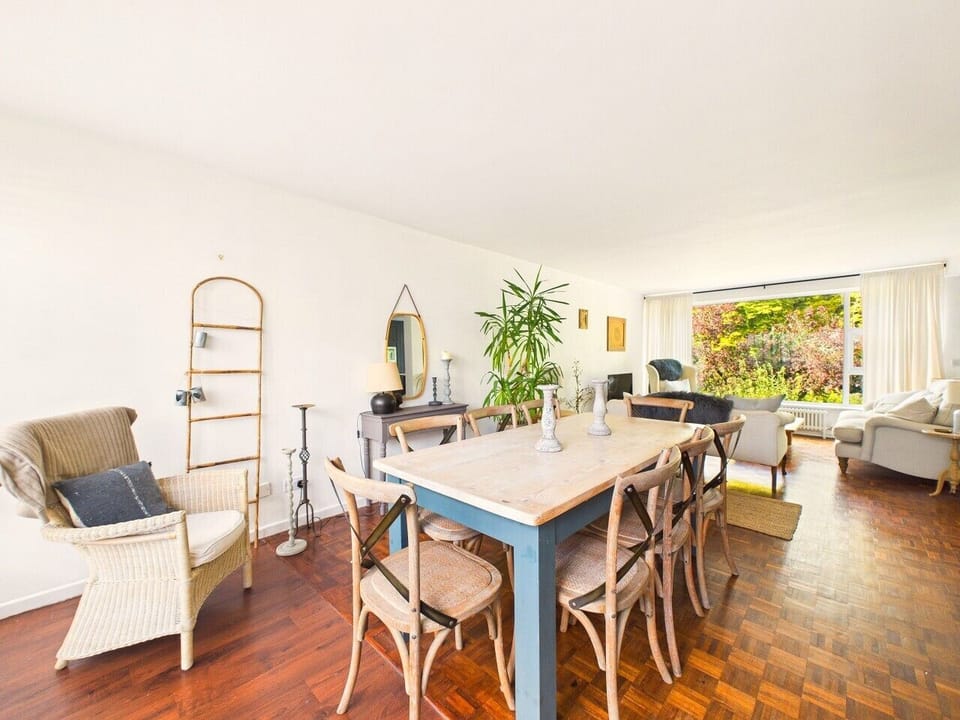 Dining and sitting rooms flow into one another, so whoever is cooking is never far from the conversation or the garden view beyond.