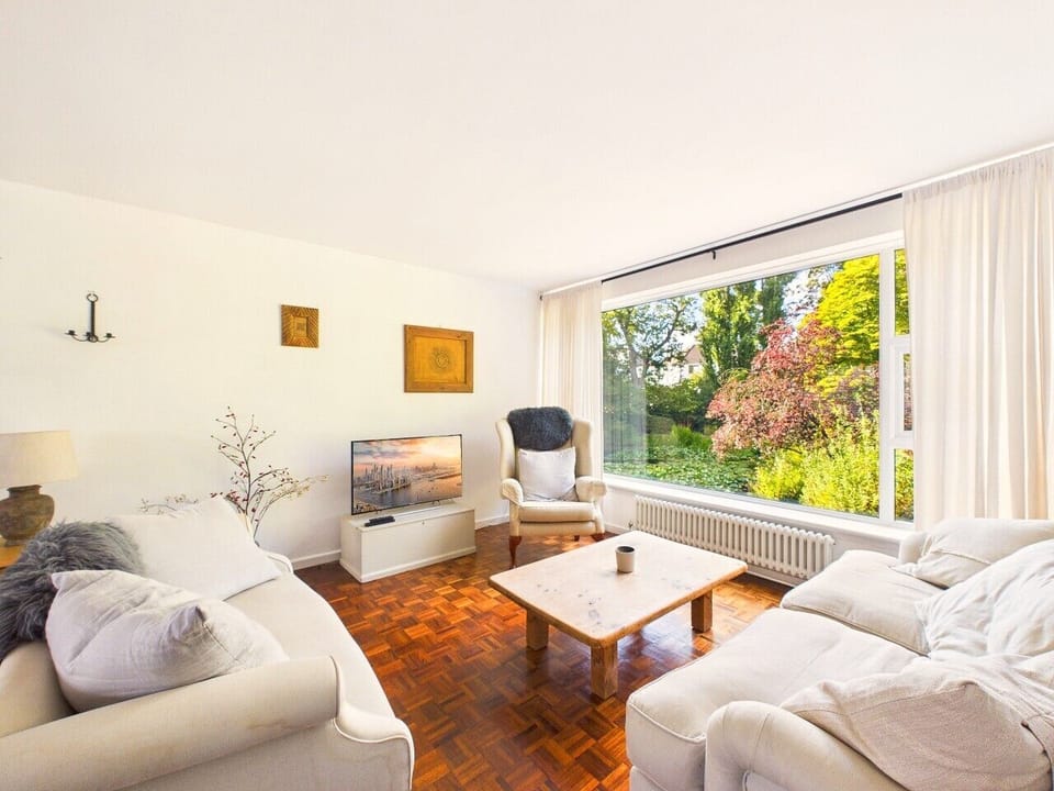 A wide parquet hallway with generous built-in storage links the bedrooms to the living space, with a full-length mirror for a last check on the way out.