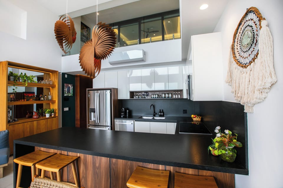 Modern kitchen featuring sleek counters, a double-door refrigerator, and a breakfast bar where you can enjoy your morning coffee