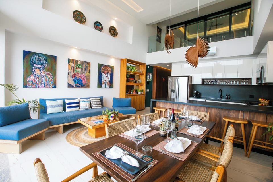 This bright, open-plan space blends your living, dining, and kitchen areas beneath soaring ceilings