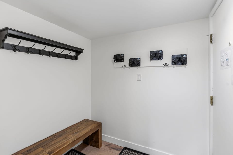 A mudroom with generous wall hooks and a rustic wooden bench keeps your gear organized and your stay hassle-free.