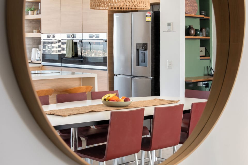 Gather around the dining table for easy meals together, with the modern, fully equipped kitchen just steps away.