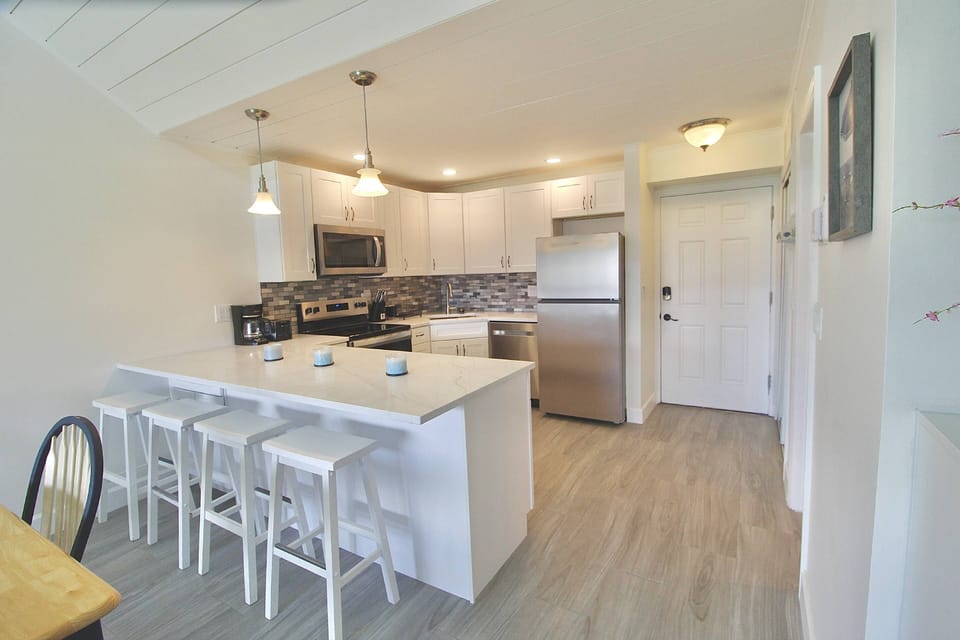 The Gorgeous newly renovated Kitchen boasts a large quartzite island with barstool seating for 4.