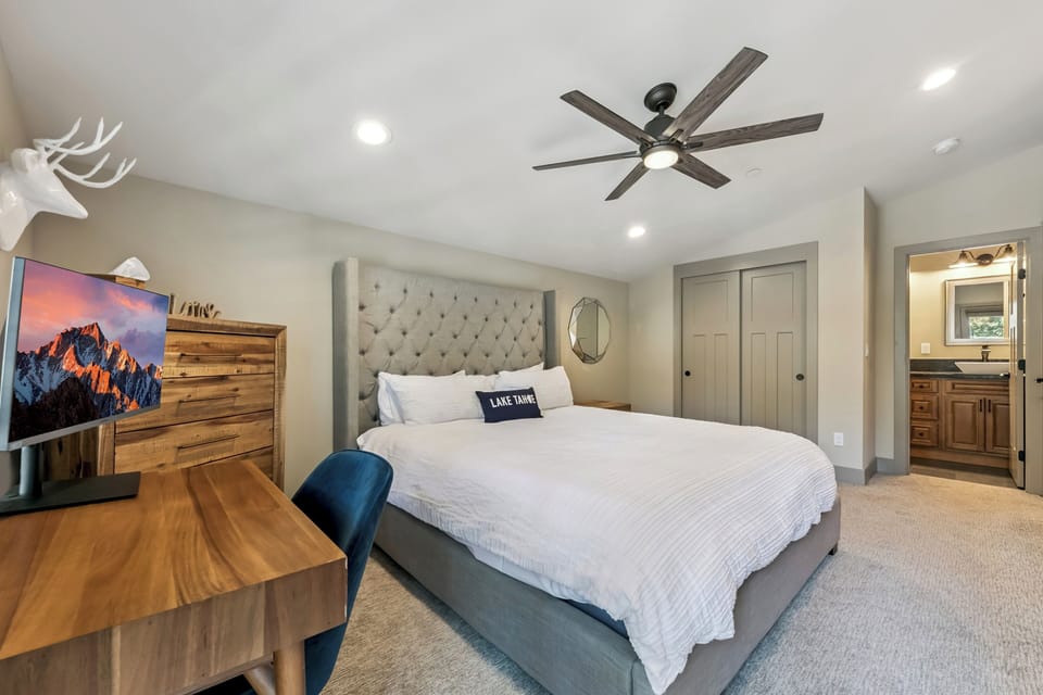 Primary bedroom upstairs - mountain charm in your private bedroom retreat. A ceiling fan keeps you comfortable while you unwind after your Lake Tahoe adventures.