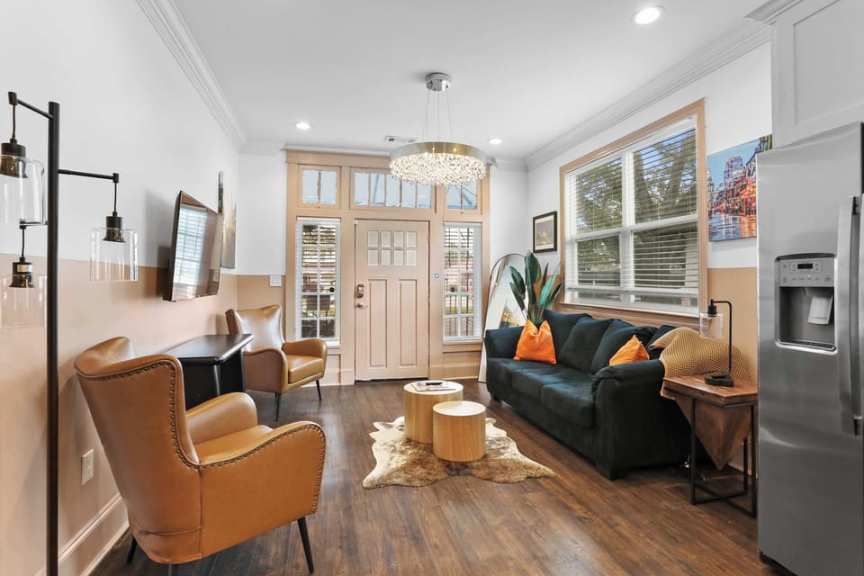 Inviting living room with comfortable seating, Smart TV, natural light, and colorful New Orleans-inspired touches throughout.